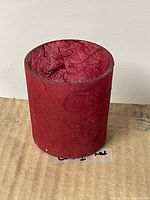 Single red paper maché glass votive holder upright