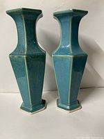 Front view of both matching faceted turquoise vases