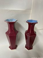 Two faceted maroon vases front view