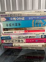 Entire stack of Chinese paperback books on a table