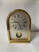 Front view showing clock face and pendulum