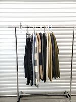 Full rack showing 15 assorted men’s sweaters on hangers