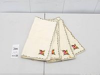 Stack of folded napkins showing embroidery and border