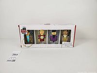 Front of boxed set showing four pixelated character glasses through window