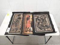 Overview of all three fabric prints laid out on a table
