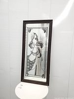Full front view of framed mirror showing entire design and frame