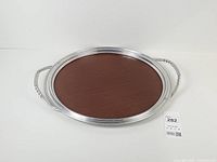 Full view of round tray showing laminate centre and handles