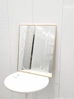 Full front view of rectangular mirror showing etched design and gold frame
