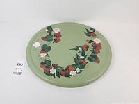 Full view of round hand-painted strawberry metal tray