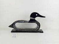 right side view of loon coin bank on base