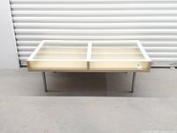 Front full view of coffee table showing glass top, frame, and legs