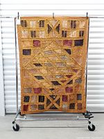 Full view of tapestry hanging on rack