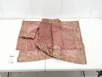 Full folded view of embroidered square textile