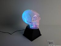 Lamp lit showing plasma effect inside skull globe on black base