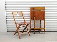 one chair open next to two chairs folded flat