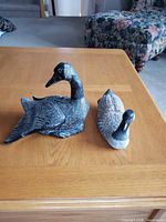 Both Canada goose sculptures on tabletop
