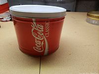 Side view showing Coca-Cola Classic logo and fitted lid