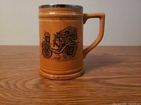 Side view of ceramic stein showing 1899 Benz graphic and handle