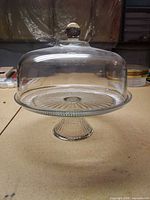 Covered glass cake stand assembled