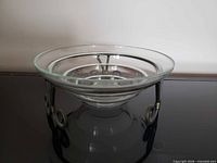 Side view showing glass bowl on metal stand