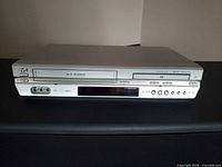Front view of JVC HR-XVC33U combo unit showing both VHS and DVD bays