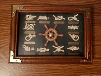 front view of entire shadow box with wood frame and knots display