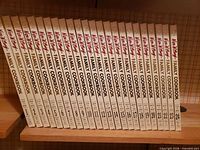 Spines of all 24 volumes 1-24 aligned on shelf