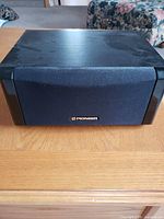 Front view of Pioneer speaker with cloth grille and logo