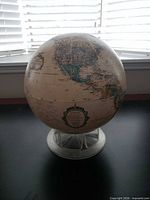 Full view of globe on stand