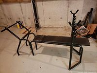 Full view of weight bench showing padded seat and barbell rack