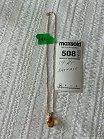 Full view of necklace and pendant with lot tag