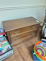 Front and top view of wooden 2-drawer chest showing size and condition