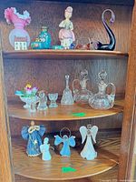 Overall view of cabinet shelves with assorted collectibles