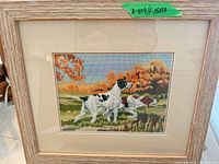 Full view of framed needlepoint artwork