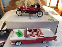 Both Franklin Mint die-cast cars on boxes: 1957 Ford Skyliner and 1911 Stanley Steamer