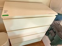 Front view showing entire white 4-drawer dresser