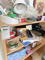 Shelves with desk lamp, tape, stapler, punches, writing supplies and organizers