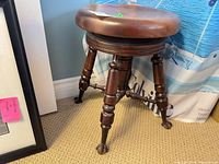 Full view of mahogany adjustable piano stool