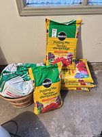 Five Miracle-Gro Potting Mix bags stacked, showing brand, volume, and condition