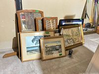 Group view of all framed artworks and mirrors leaning against wall