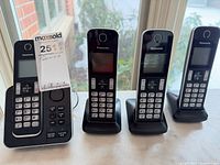 Full view of base unit and three handsets on cradles