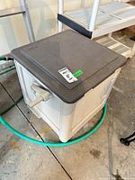 overall view of SunCast hose box with crank and hose attached