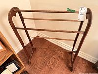 Full view of wooden blanket stand showing three rails and side panels