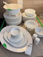 Group view of all white dinnerware pieces on countertop