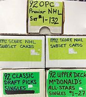 Front of five storage boxes showing handwritten labels detailing sets and subsets inside