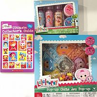 Front view of all three sealed Lalaloopsy items: board game, bath set, guide book