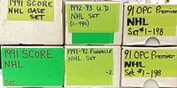 Six labelled storage boxes identifying 1991 Score, 1992-93 Upper Deck, 1991-92 Pinnacle and 1991 O-Pee-Chee Premier sets