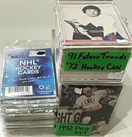 Front view showing sealed packs and two card storage boxes with green labels identifying 1991 Future Trends ’72 Hockey Canada and 1992 Pro Set