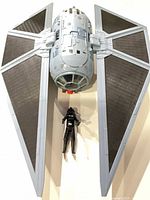 Top view of TIE Striker with pilot figure beneath showing scale and wing design