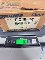 Box on scale showing 8.3 lb and box label with size and brand